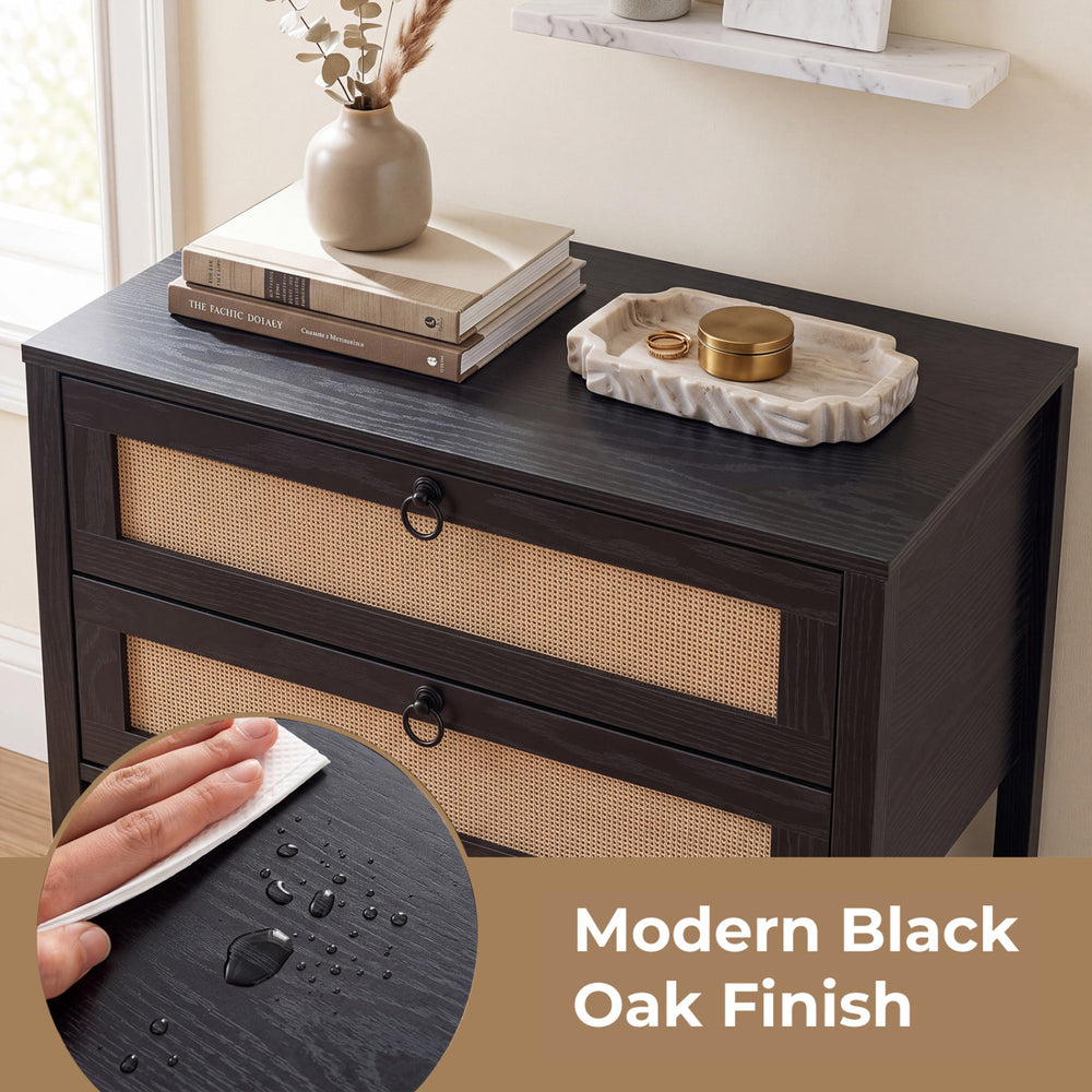 Boho rattan nightstand in modern black oak finish features two drawers and an open shelf for versatile storage.