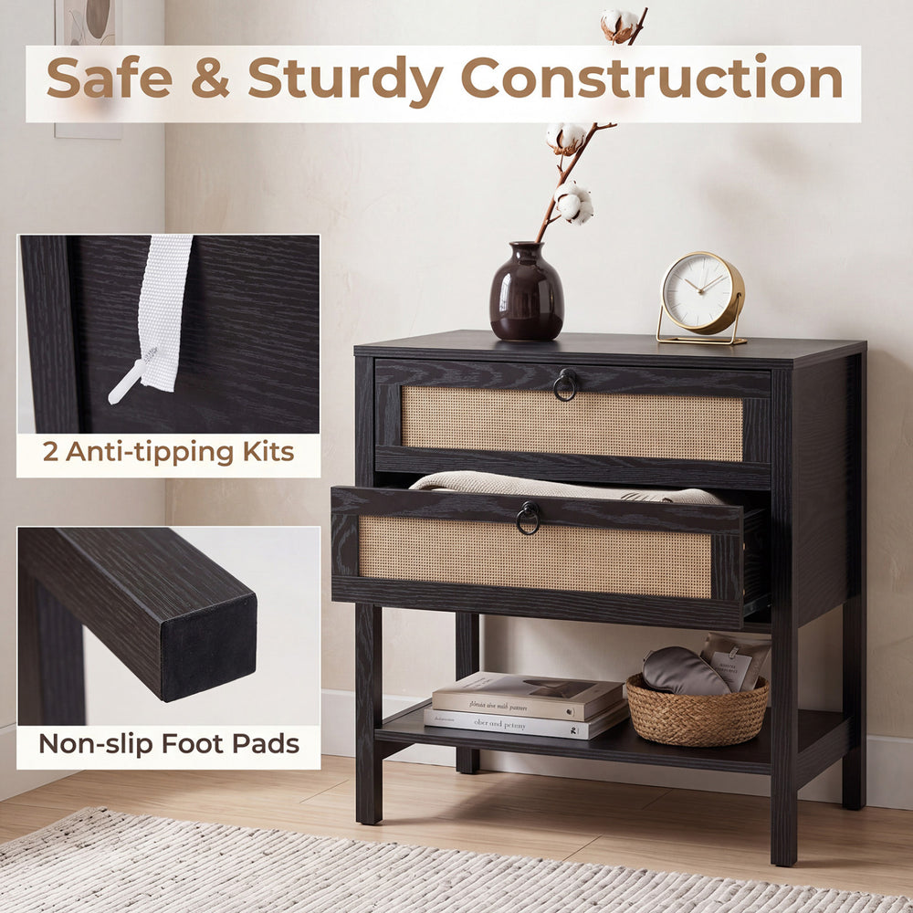 Boho rattan nightstand in black featuring two drawers, a bottom shelf, and non-slip foot pads for stability.