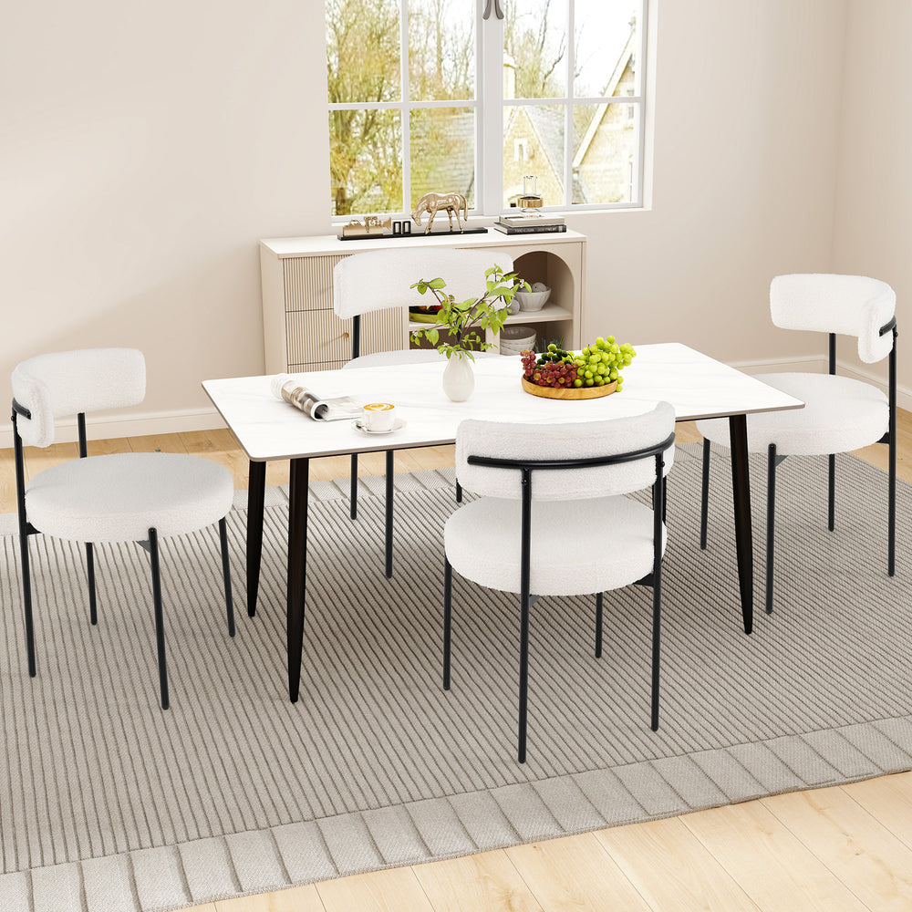 Set of two white boucle dining chairs with curved backrest and metal legs, perfect for dining room or living space.