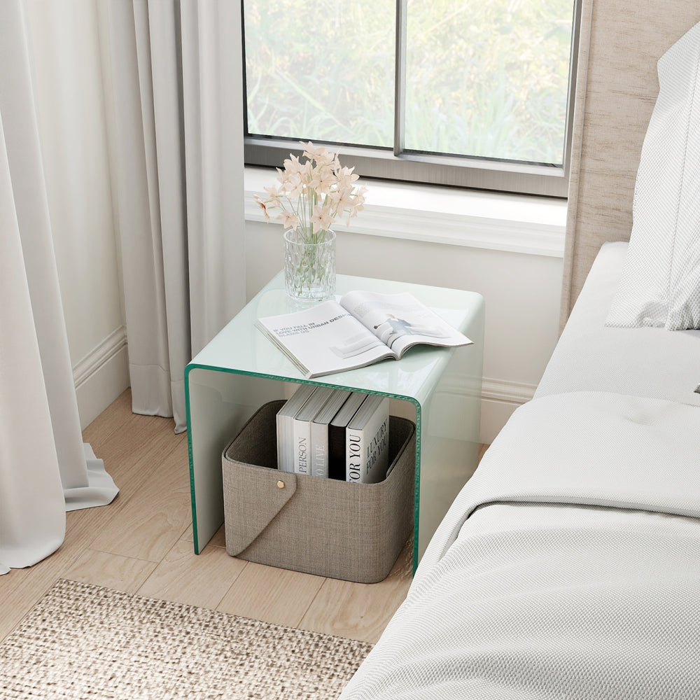 C-shaped end table with tempered glass top and shelf, ideal for use as a nightstand or coffee table in modern decor.