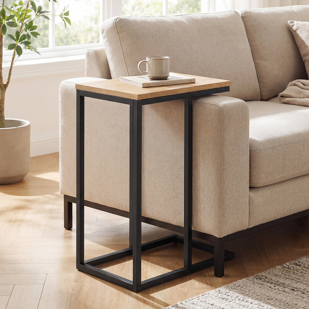 C-shaped end table featuring a natural wood surface and a robust metal frame, designed for easy access beside seating.
