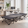 Gray camping cot with padded pillow and side storage pouch, featuring a stable construction for indoor and outdoor use.
