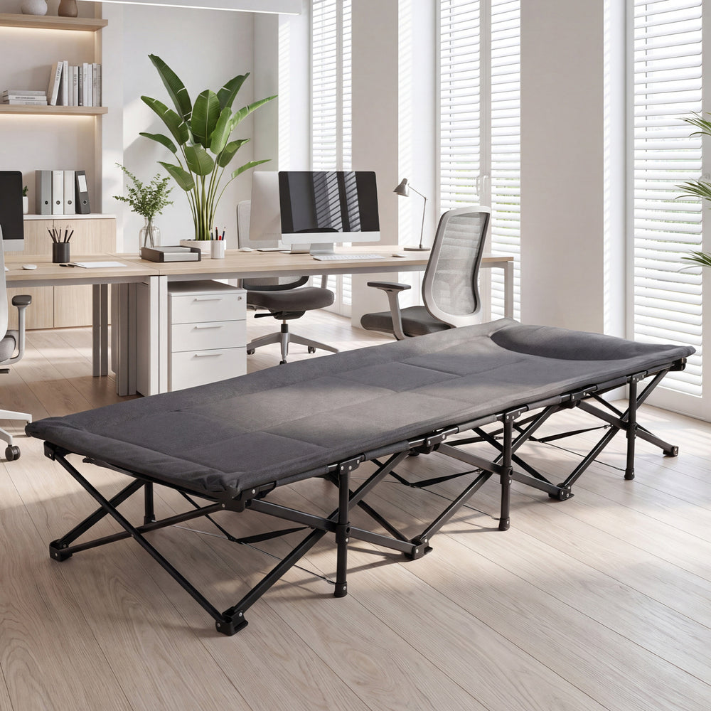 Gray camping cot with padded pillow and side storage pouch, featuring a stable construction for indoor and outdoor use.