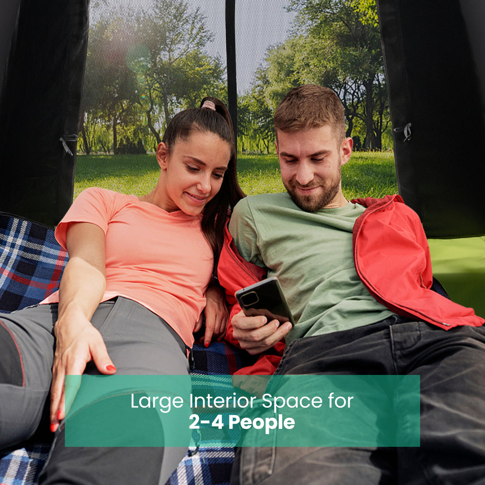 Large interior space for 2-4 people in a pop-up camping tent, featuring mesh windows for ventilation and a removable.