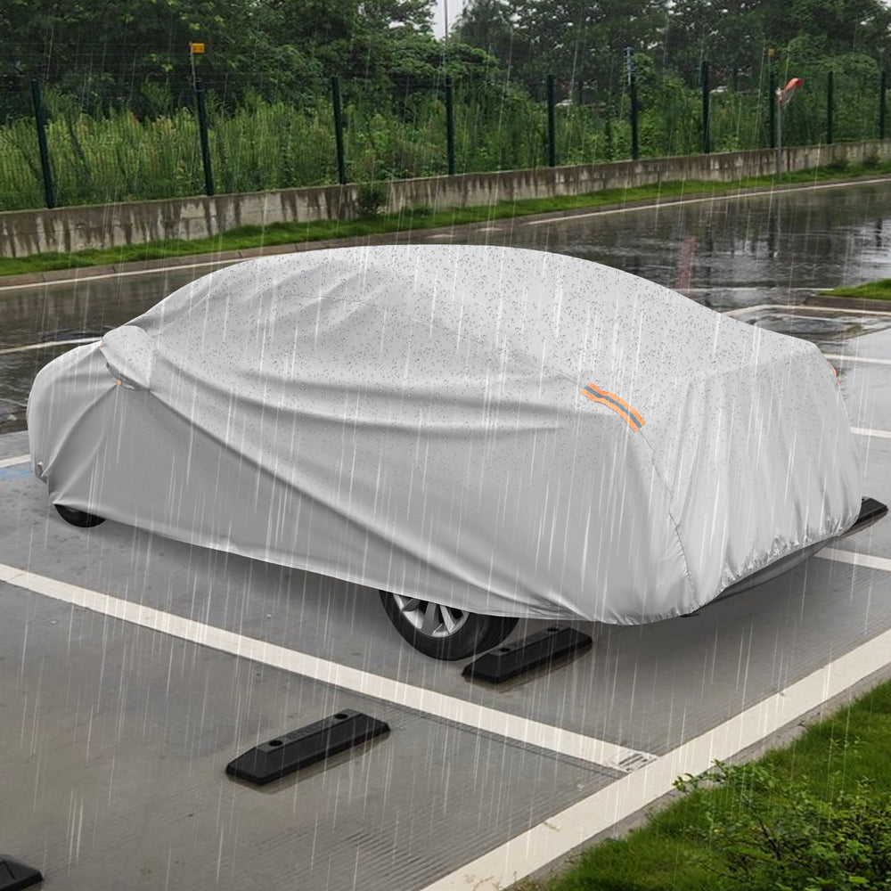 Car cover for 193-inch sedans, waterproof and tear-proof, shown in rainy conditions for ultimate weather protection.