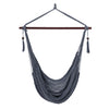 Gray Caribbean hammock chair with metal spreader bar, made of soft-spun rope, ideal for indoor or outdoor relaxation.
