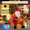 Christmas inflatable Santa Claus on sofa with elf and gift boxes, featuring warm white LED lights for festive charm.