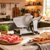 Commercial meat slicer with a 10" carbon steel blade, adjustable thickness, and aluminum housing for versatile kitchen use.