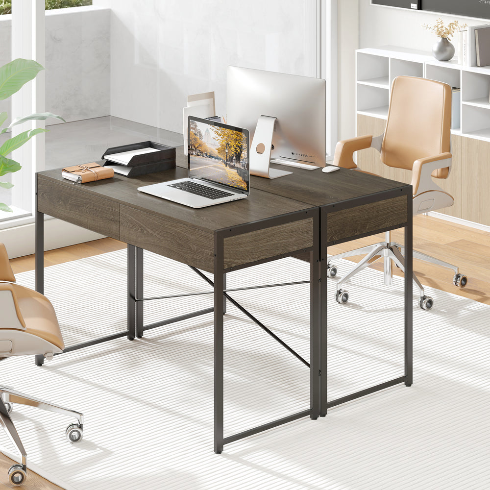 Computer desk with a spacious oak tabletop and metal frame, featuring two drawers for organized office storage.