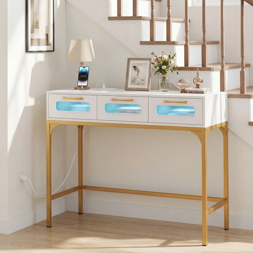 Console table with LED lighting and charging station in white, featuring three drawers and gold legs, ideal for living.