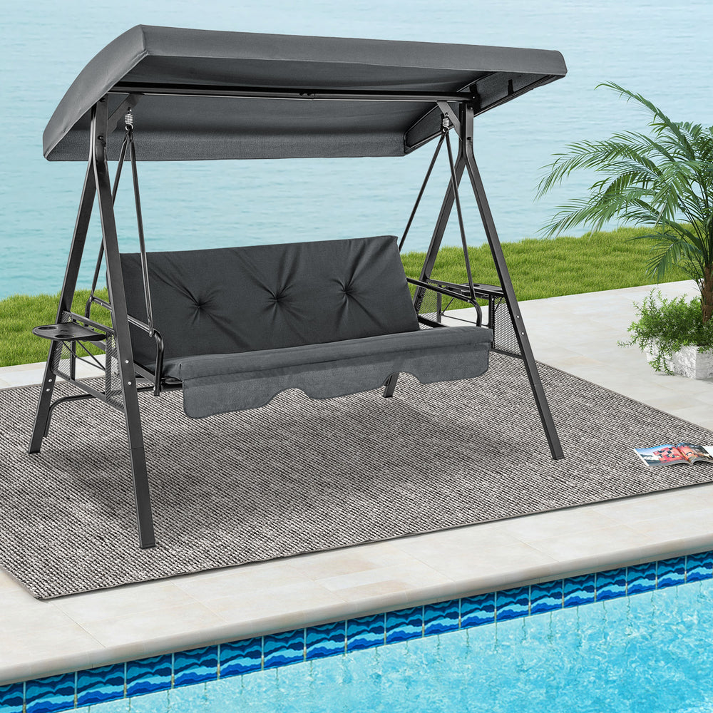 Convertible 3-seat patio porch swing chair in gray with adjustable canopy, ideal for poolside relaxation.