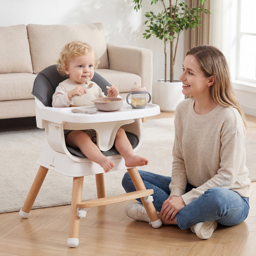 Convertible high chair in gray with solid wood legs, adjustable tray, and comfortable PU cushion for babies and.