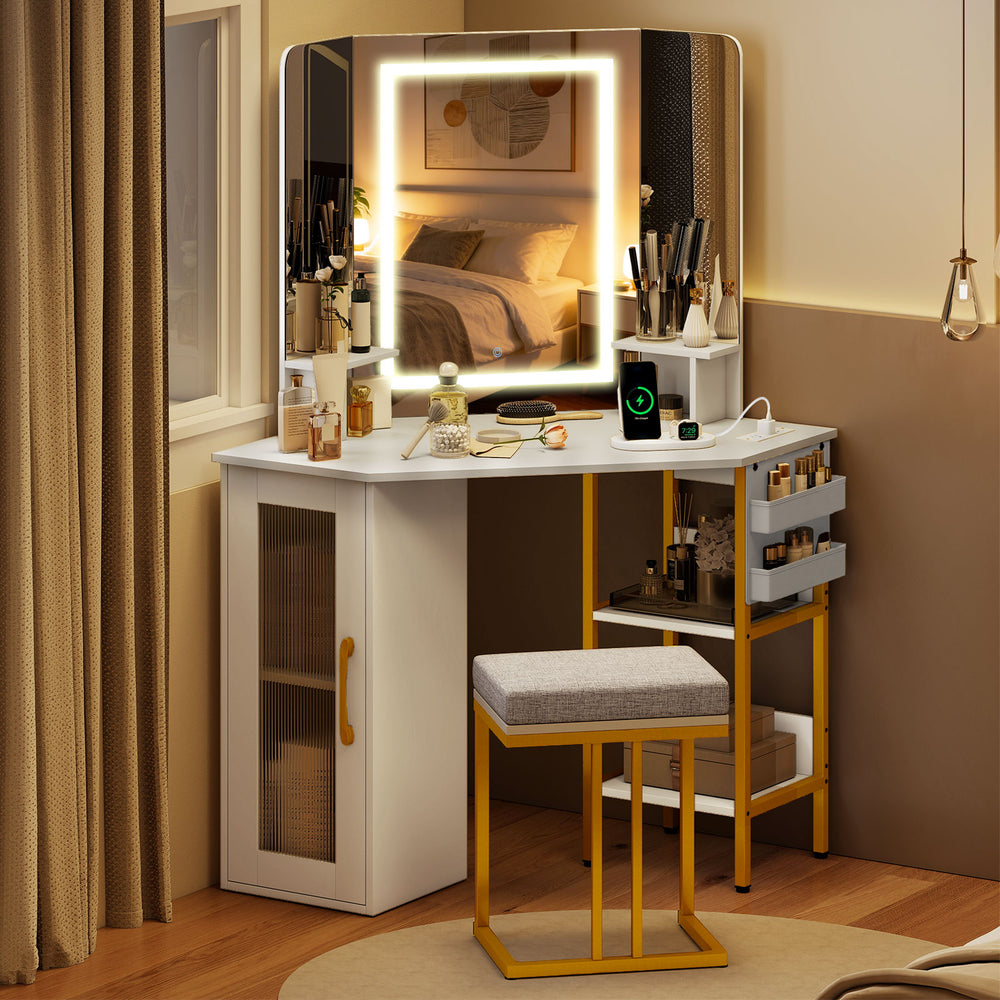 Corner vanity desk with triple mirror and adjustable lights, featuring storage for cosmetics and a comfortable stool.