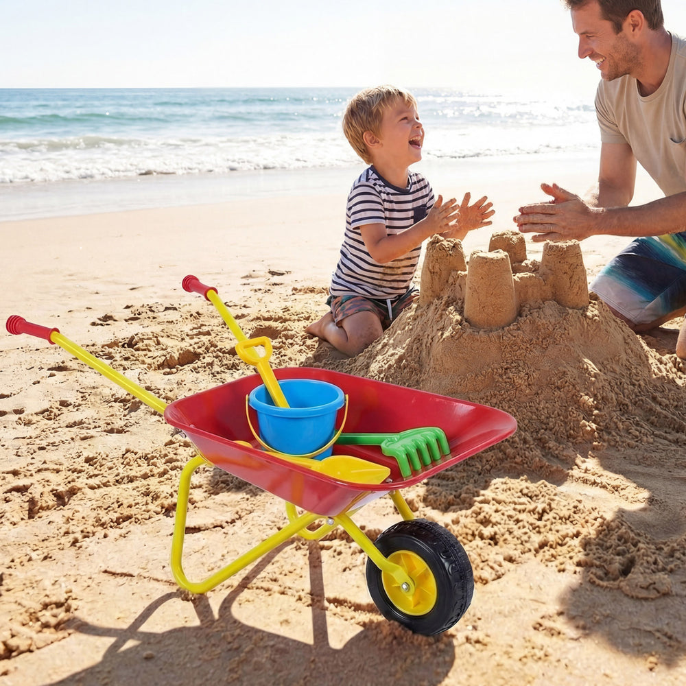 Kids wheelbarrow in red with all-terrain wheels, perfect for hauling toys and sand at the beach with a child.