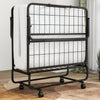 Folding bed with memory foam mattress and pillow, featuring a space-saving design and wheels for easy movement.