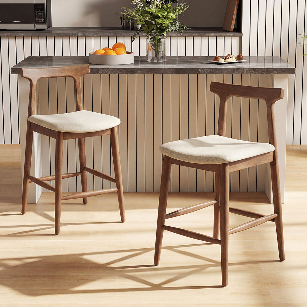 Counter height bar stools with curved backs in walnut, featuring breathable fabric and ergonomic design for kitchen.
