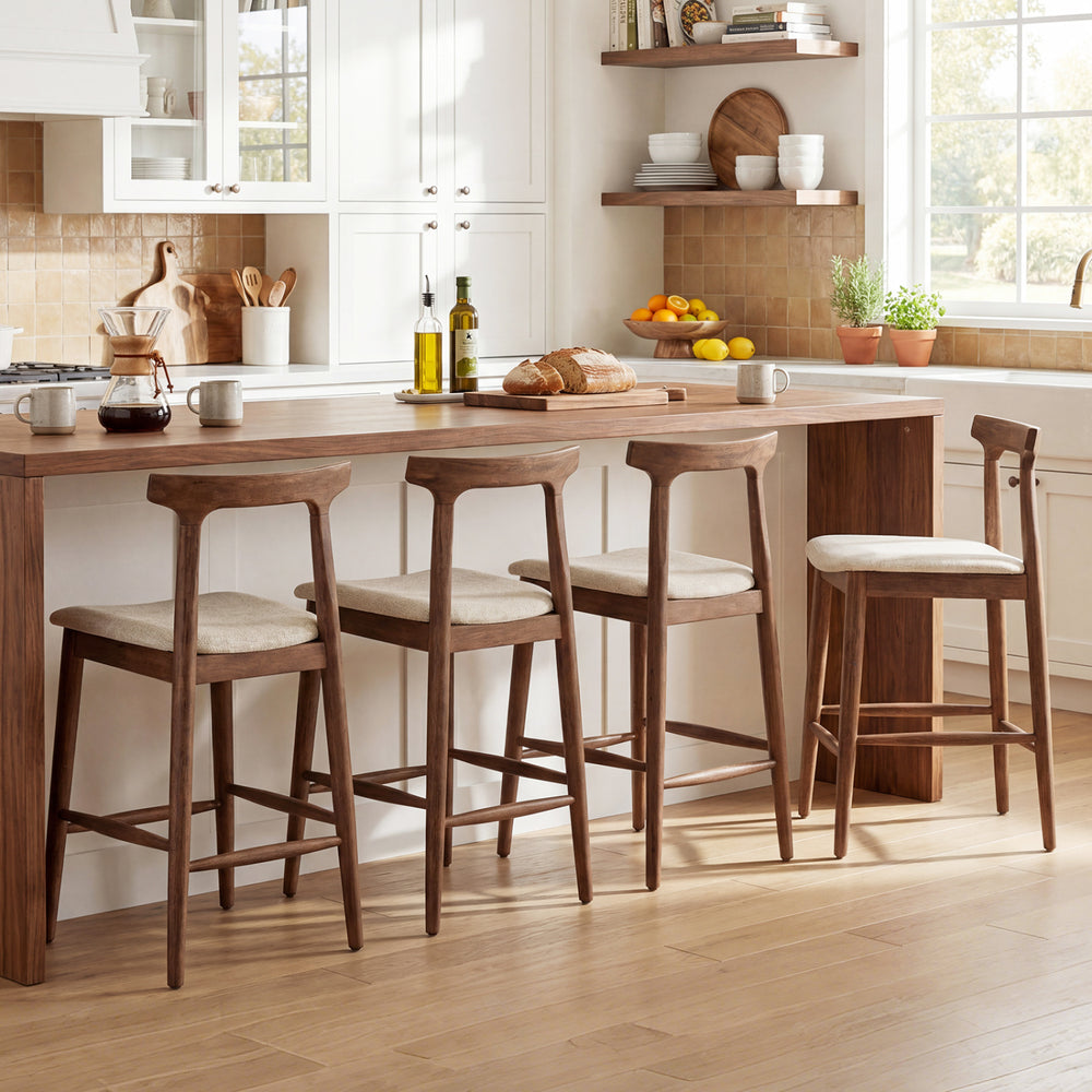 Counter height bar stools with curved backs in walnut, featuring soft upholstery and ergonomic design for kitchen.