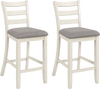 Counter height chairs with beige fabric seats and rubber wood legs, offering comfort and vintage elegance for dining.