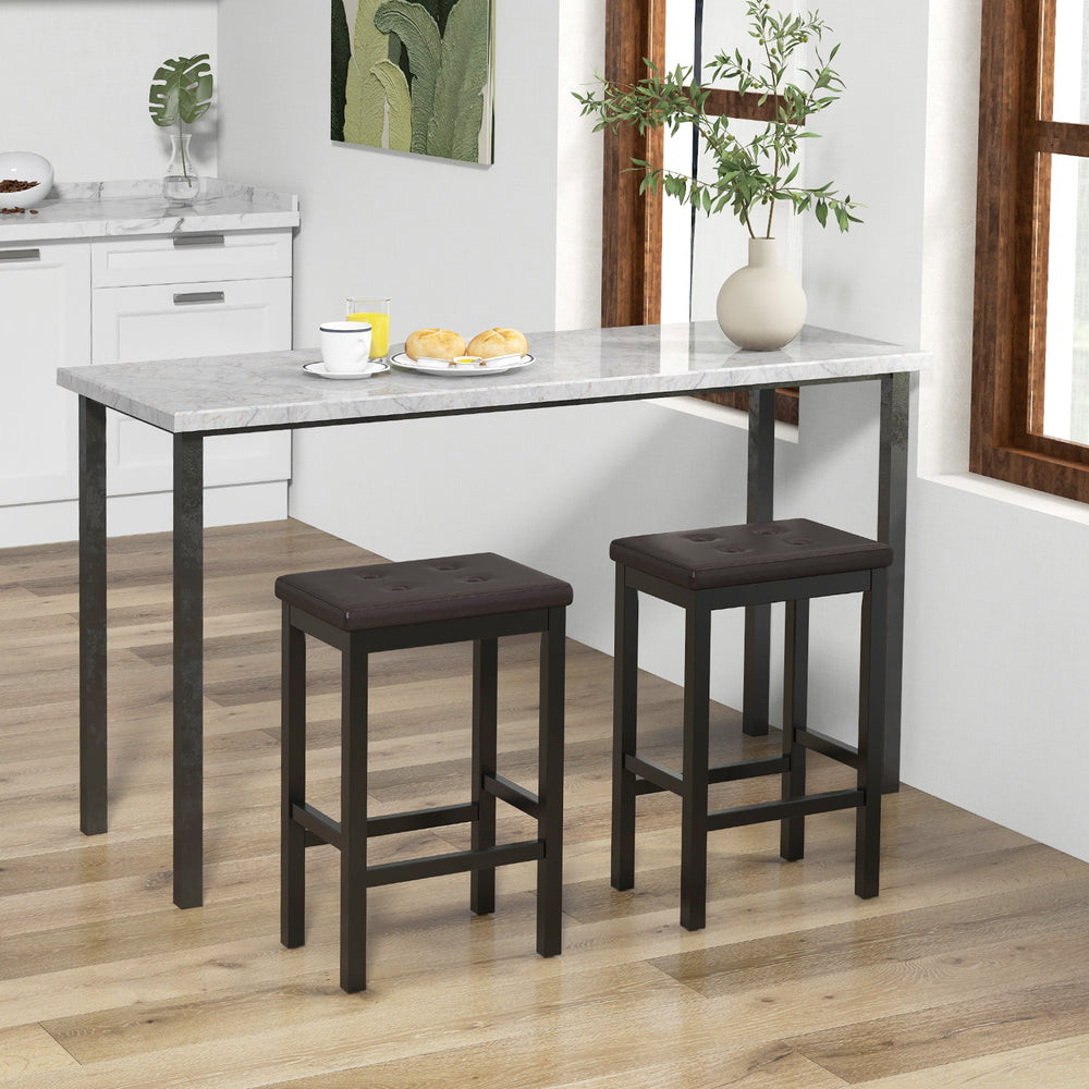 Brown 24-inch bar stools with padded seats and rubber wood frames, featuring tufted buttons and footrests for comfort.