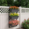 Three-tier black deck railing planter boxes with adjustable brackets, ideal for growing flowers and herbs in sunlight.