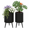 Set of 2 decorative flower pots with a modern fluted design, featuring drainage holes and stable metal legs for versatile decor.