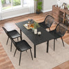 Top view of a modern dining table set with black kitchen chairs featuring metal legs and cutout backrests, perfect for.