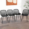 Set of four black modern kitchen chairs with metal legs and cutout backrests, ideal for dining rooms and home offices.