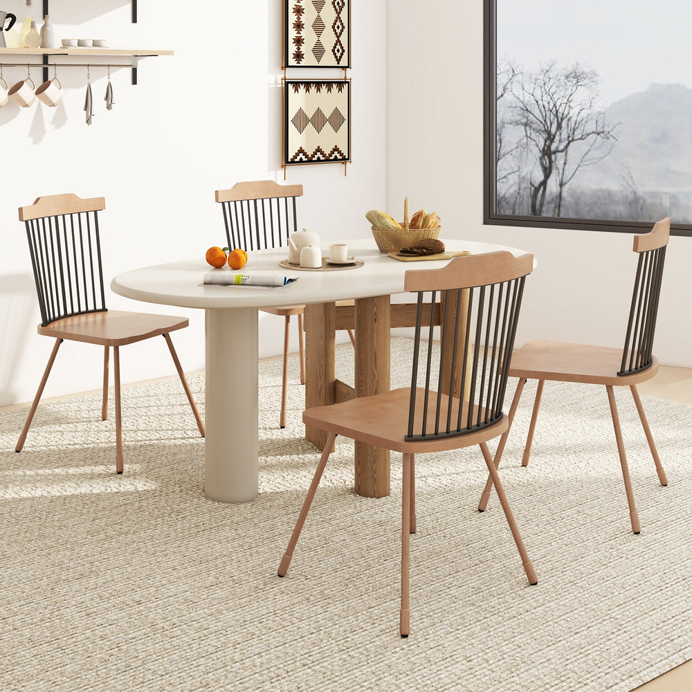 Set of two natural dining chairs with spindle back, ergonomic contoured seat, and sturdy bentwood construction.