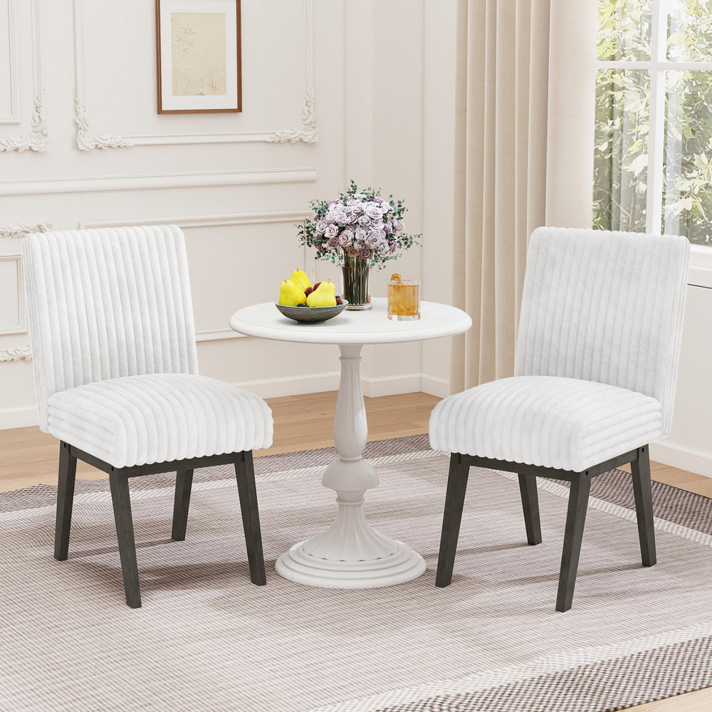 White fabric upholstered dining chairs with padded seats and rubber wood legs, perfect for kitchen or dining room.