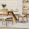 Natural rubber wood dining chairs with fabric upholstery and spindle backrest, ideal for kitchen or dining room use.