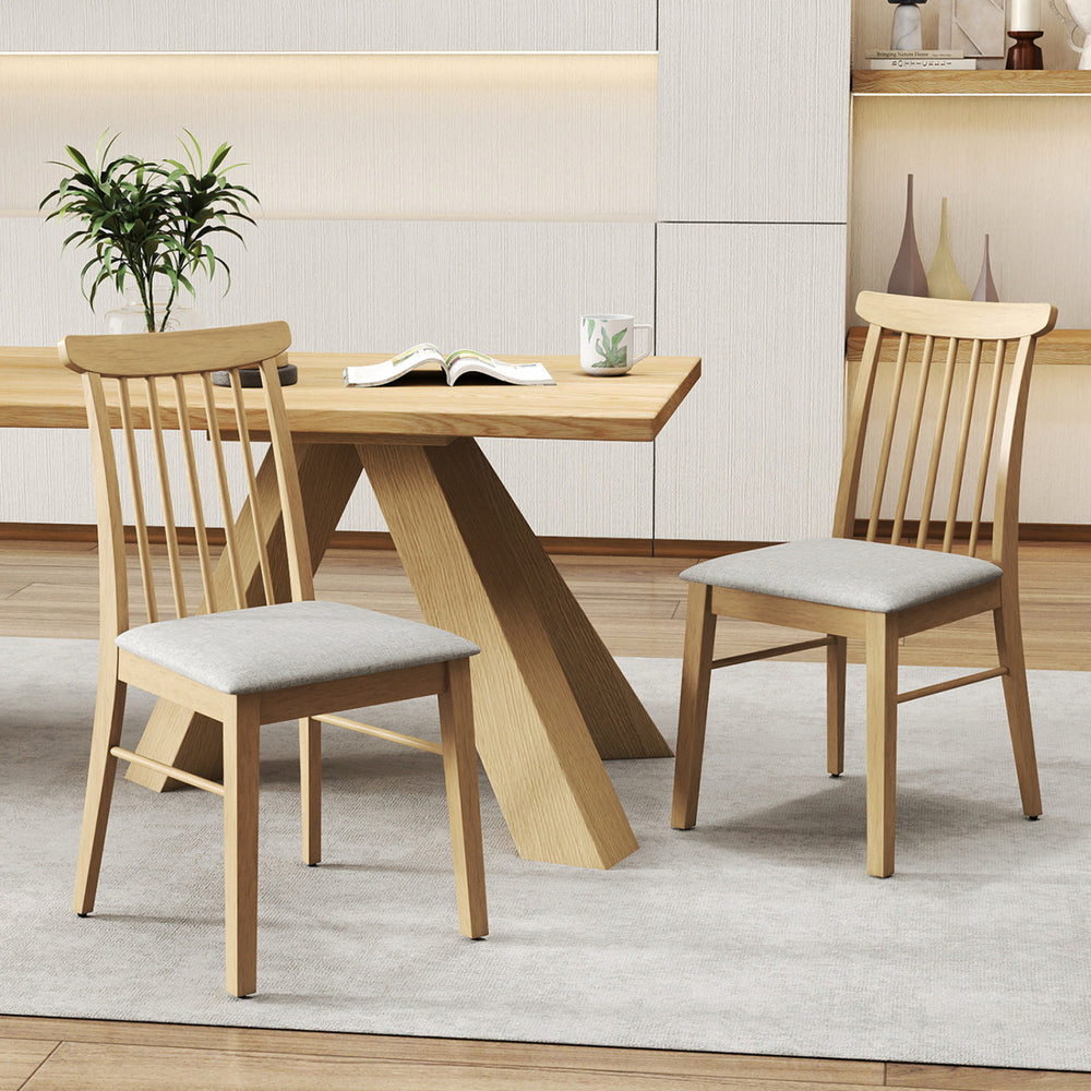 Natural rubber wood dining chairs with fabric upholstery and spindle backrest, ideal for kitchen or dining room use.