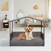Wicker dog house with weatherproof roof and soft cushion, ideal for indoor and outdoor use in various settings.