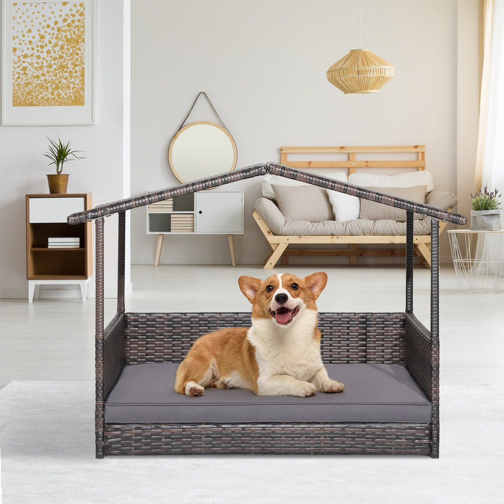 Wicker dog house with weatherproof roof and soft cushion, ideal for indoor and outdoor use in various settings.