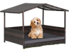 Outdoor wicker dog house with weatherproof roof and soft cushion, perfect for yard or garden use.