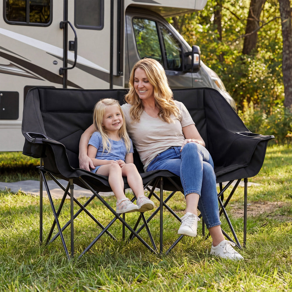 Double camping chair in black, featuring cup holders and mesh pockets, perfect for outdoor relaxation with a friend.