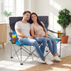 Double camping chair in blue with cup holders, featuring sturdy frame and soft padding for two-person comfort indoors.