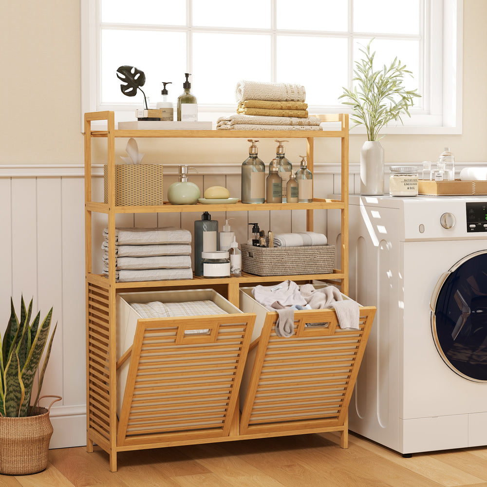 Natural bamboo double tilt-out laundry hamper showcasing slatted design and two removable baskets for optimal airflow and storage.
