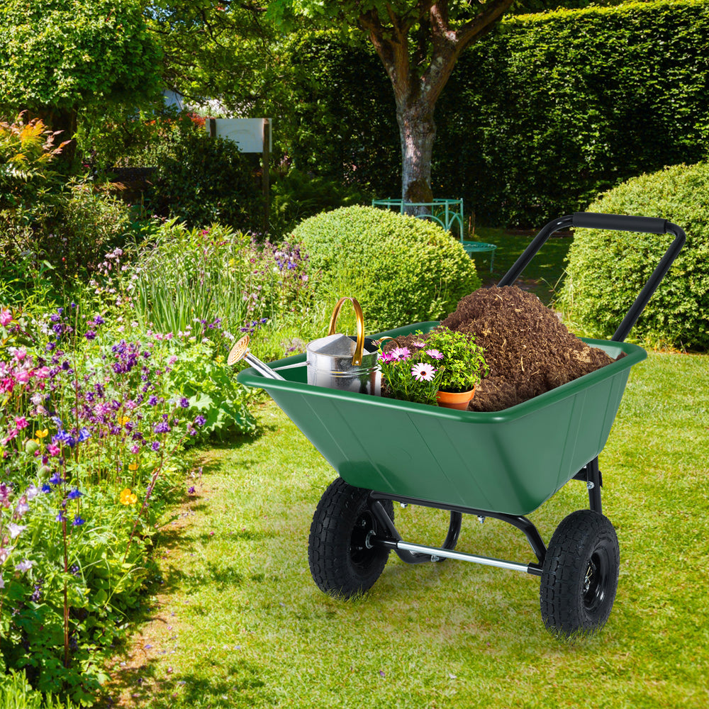 Dual-wheel garden utility cart in green filled with mulch, ideal for transporting materials with easy maneuverability.