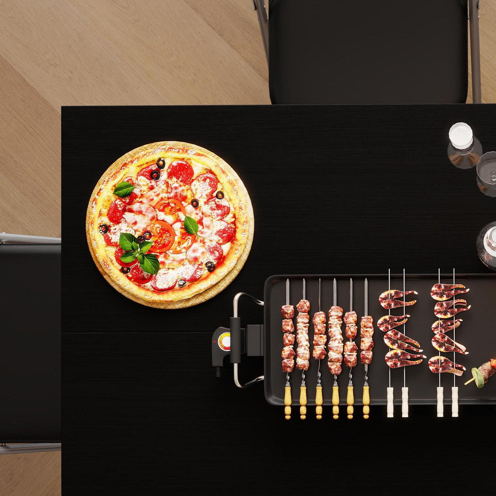 Griddle grill with skewers and pizza on a dining table, part of a compact living dining and storage bundle.