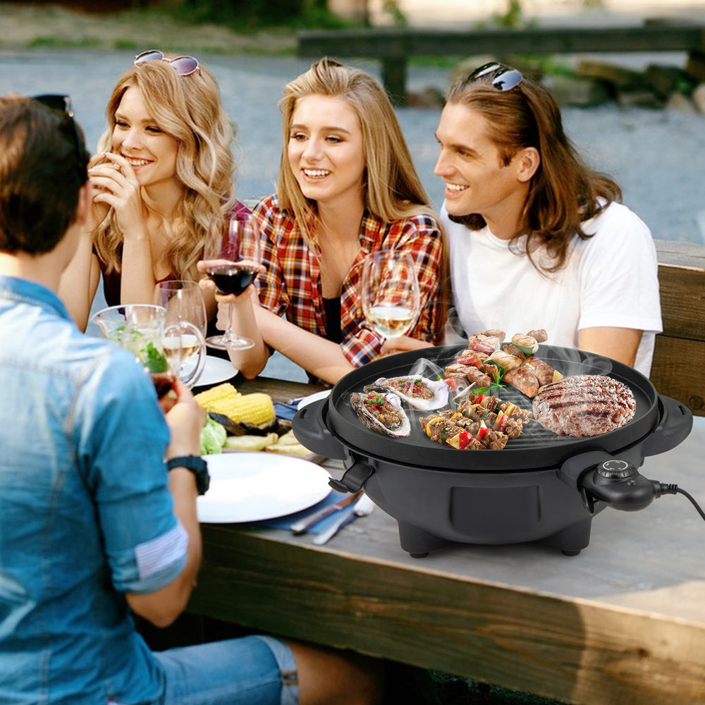 Electric BBQ grill with non-stick grilling plate, perfect for 10 people, shown in use outdoors with friends.