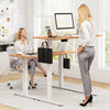 Electric standing desk with natural wood finish, featuring 3 memory height settings and integrated hooks for storage.