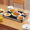 Electric warming food warmer on a wooden table, featuring adjustable temperature control for buffets and gatherings.