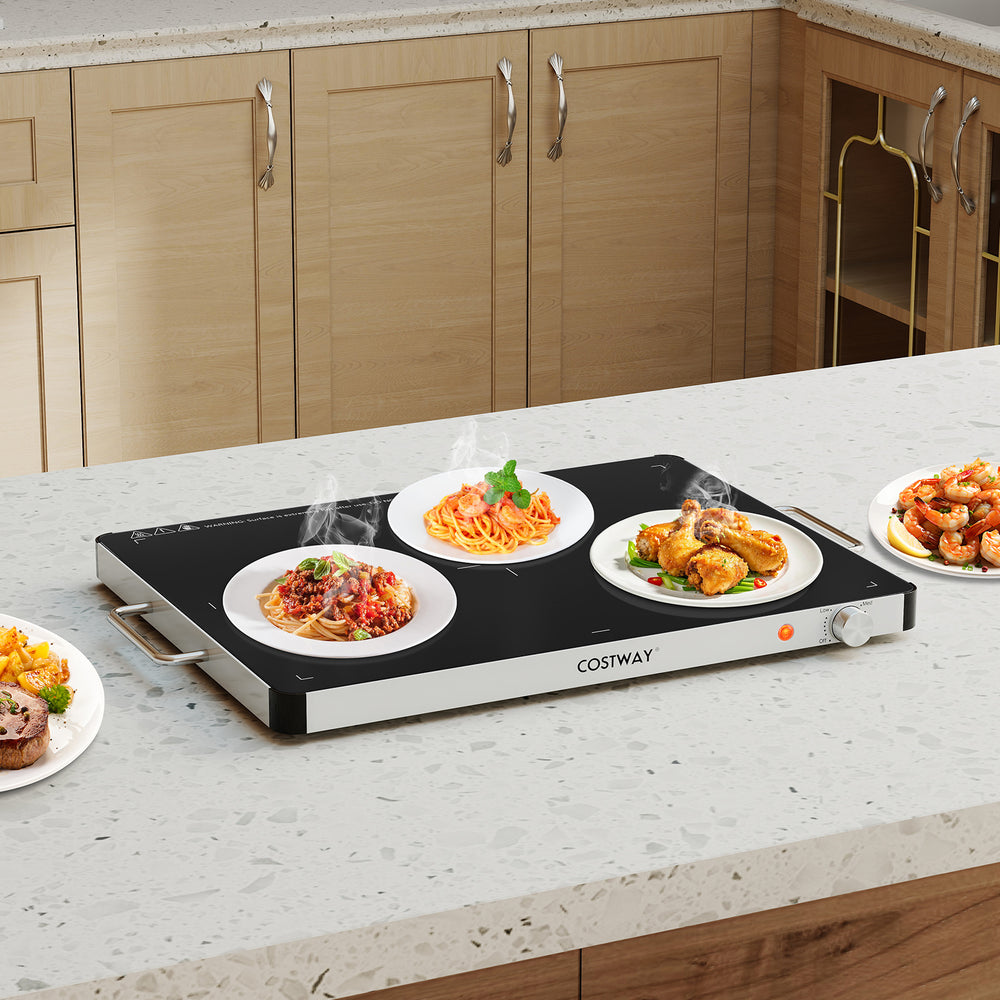Electric warming food warmer with adjustable temperature control, displaying multiple plates of food on a smooth glass.