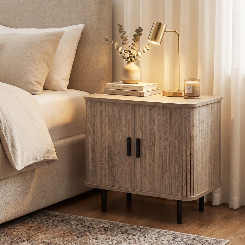 Modern mid-century nightstand with sliding tambour doors and storage shelf, featuring a natural wood finish and metal.