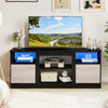 Entertainment center in black with adjustable shelf, RGB LED lighting, and storage for 65” TVs, perfect for modern.