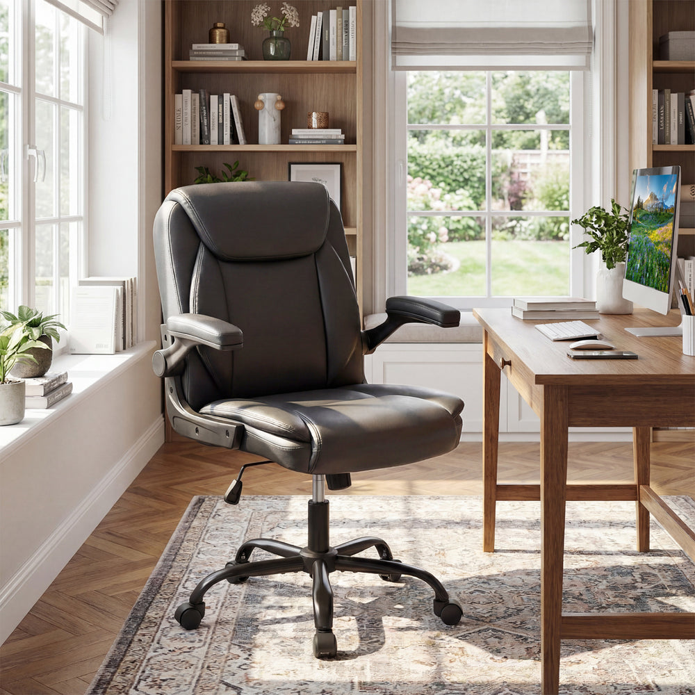 Ergonomic black leather office chair with flip-up armrests and rocking function, ideal for comfortable workspace.