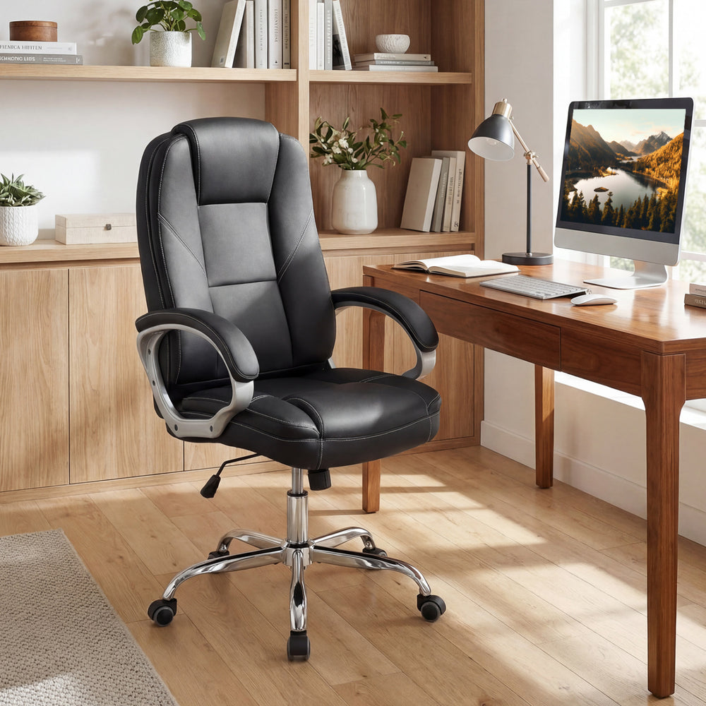 Ergonomic black leather office chair with padded armrests and a contoured backrest, ideal for comfortable long sitting.