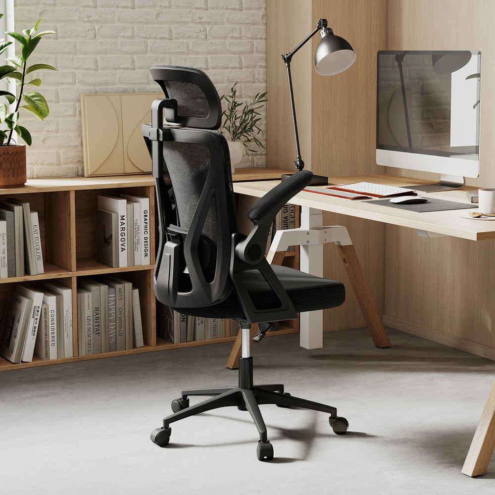 Ergonomic black mesh office chair with adjustable lumbar support and flip-up armrests, perfect for workspace comfort.