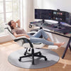 Ergonomic gray video game chair with headrest, reclining backrest, and retractable footrest for home office comfort.