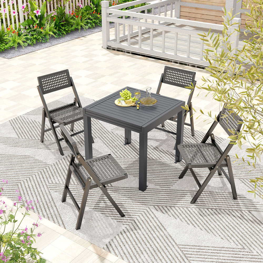 Expandable grey patio dining table for 4-6 people with slatted top, set in an outdoor setting with folding chairs.